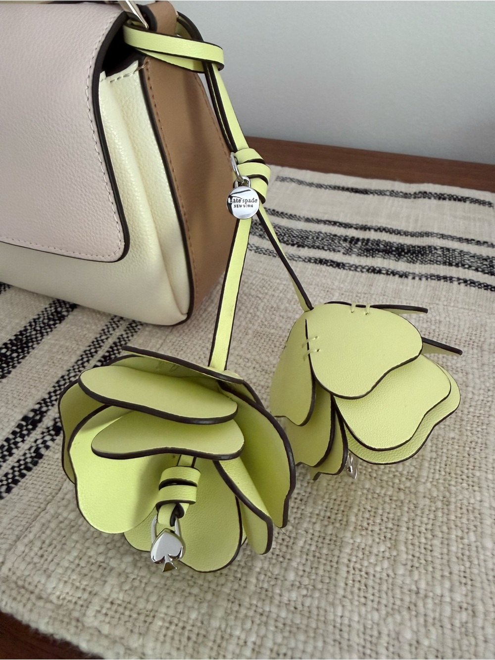 Yellow Kate Spade flower bag charm